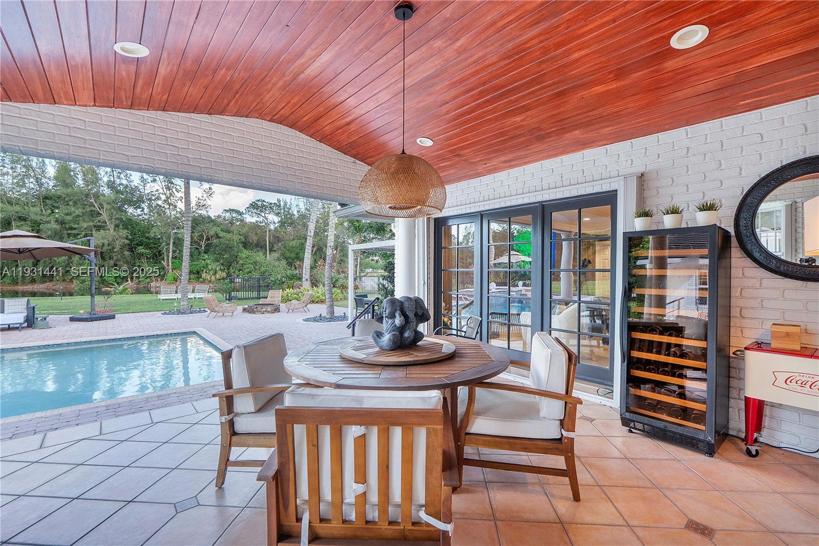 8020 Northwest 47th Drive Coral Springs, FL 33067 - Photo 36 of 83 a view of a patio with a table chairs and backyard