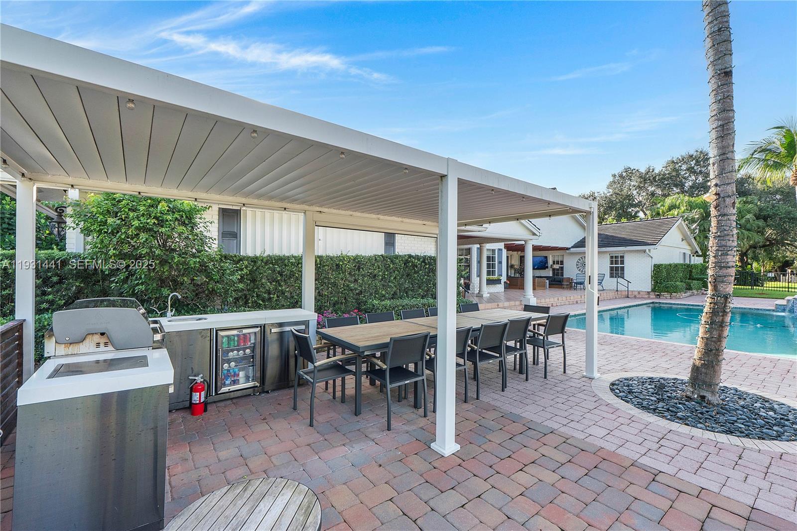 8020 Northwest 47th Drive Coral Springs, FL 33067 - Photo 42 of 83 a view of a patio with table and chairs potted plants and floor to ceiling window