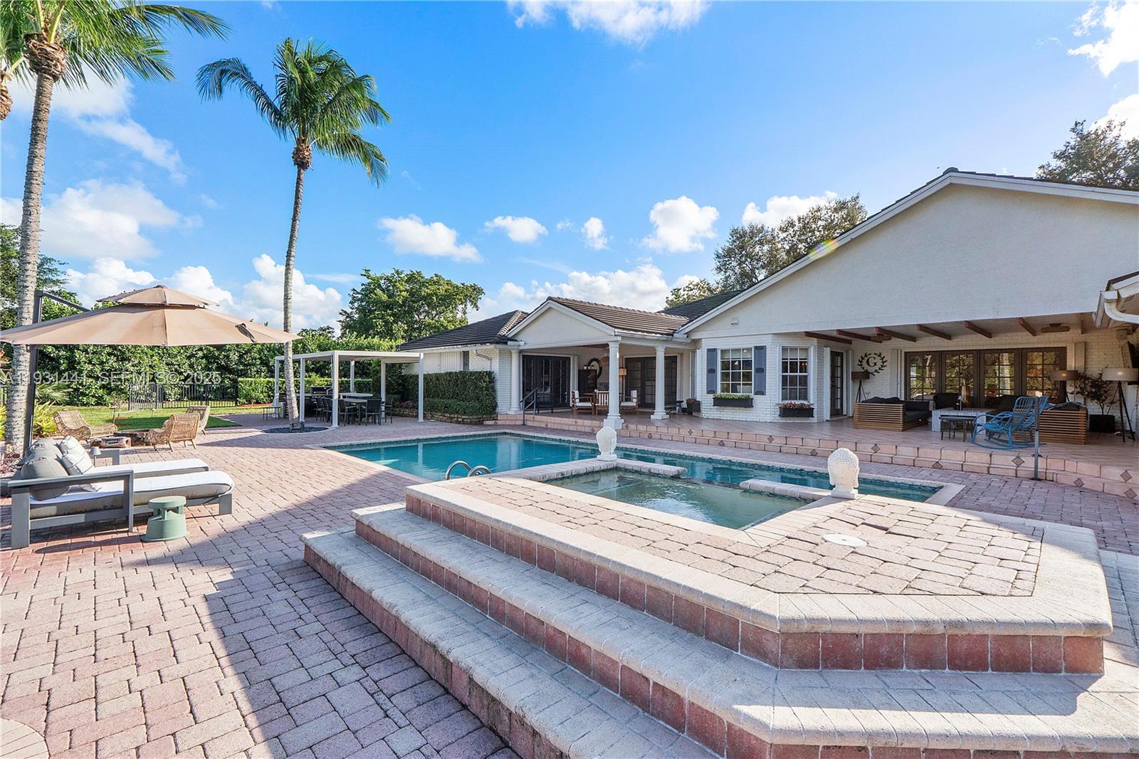 8020 Northwest 47th Drive Coral Springs, FL 33067 - Photo 43 of 83 a view of house with swimming pool outdoor seating
