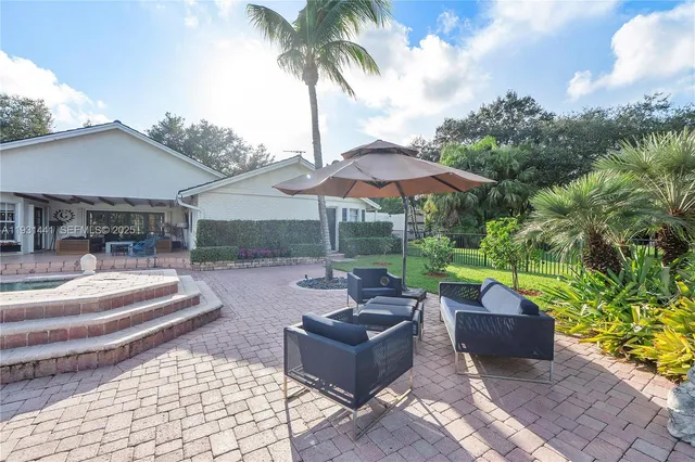 a view of a street with a building and palm trees