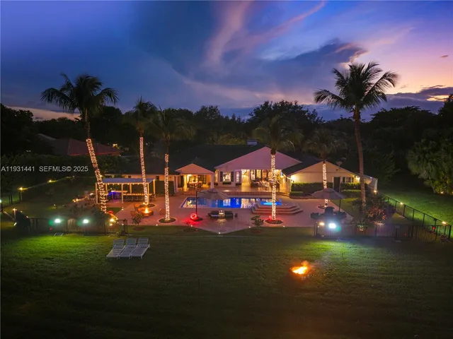 a front view of a house with swimming pool having outdoor seating