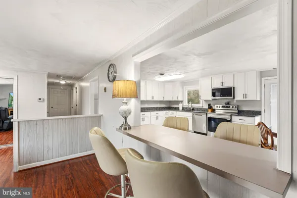 a kitchen with stainless steel appliances granite countertop a microwave a sink and a stove