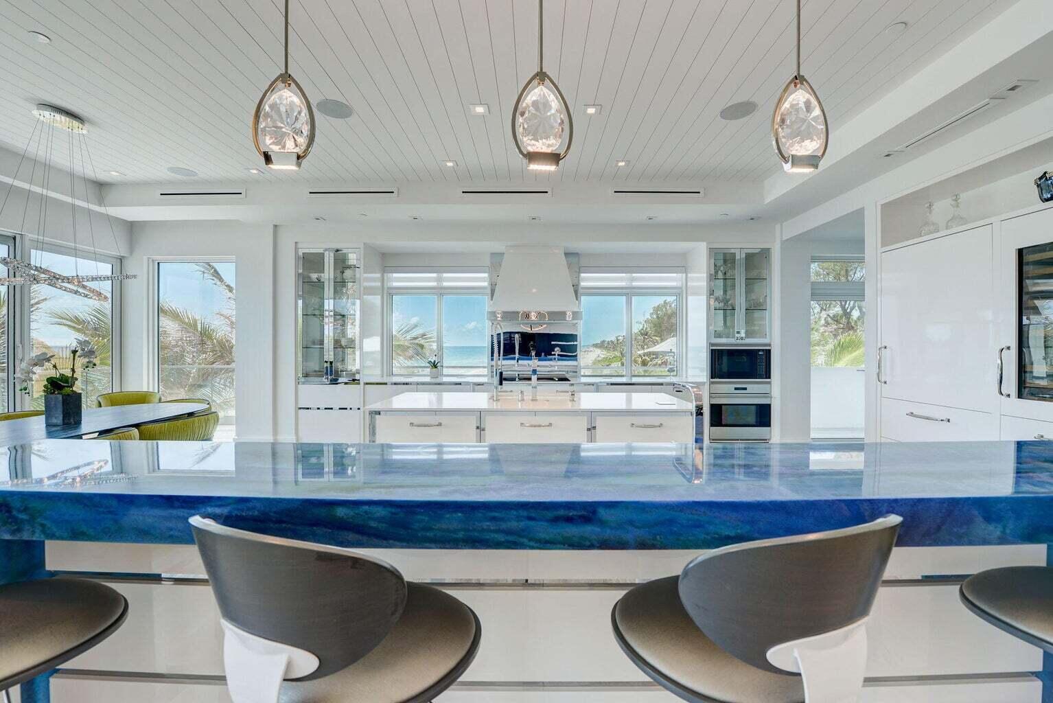 5001 Old Ocean Boulevard Ocean Ridge, FL 33435 - Photo 15 of 66 a room with wooden floor and lots of frames on wall