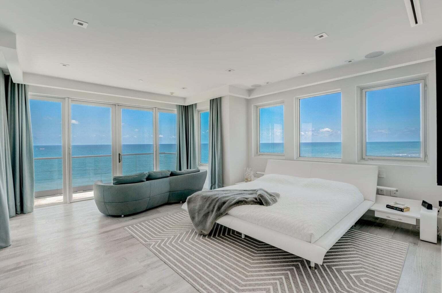 5001 Old Ocean Boulevard Ocean Ridge, FL 33435 - Photo 33 of 66 a bedroom with a bed and glass window