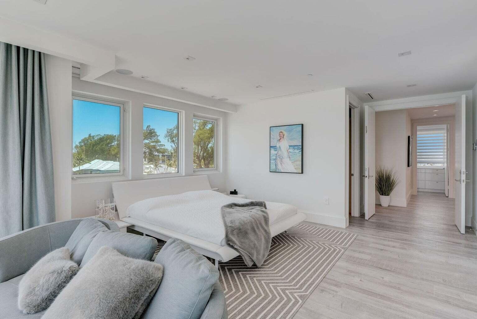 5001 Old Ocean Boulevard Ocean Ridge, FL 33435 - Photo 35 of 66 a spacious bedroom with a bed and a couch