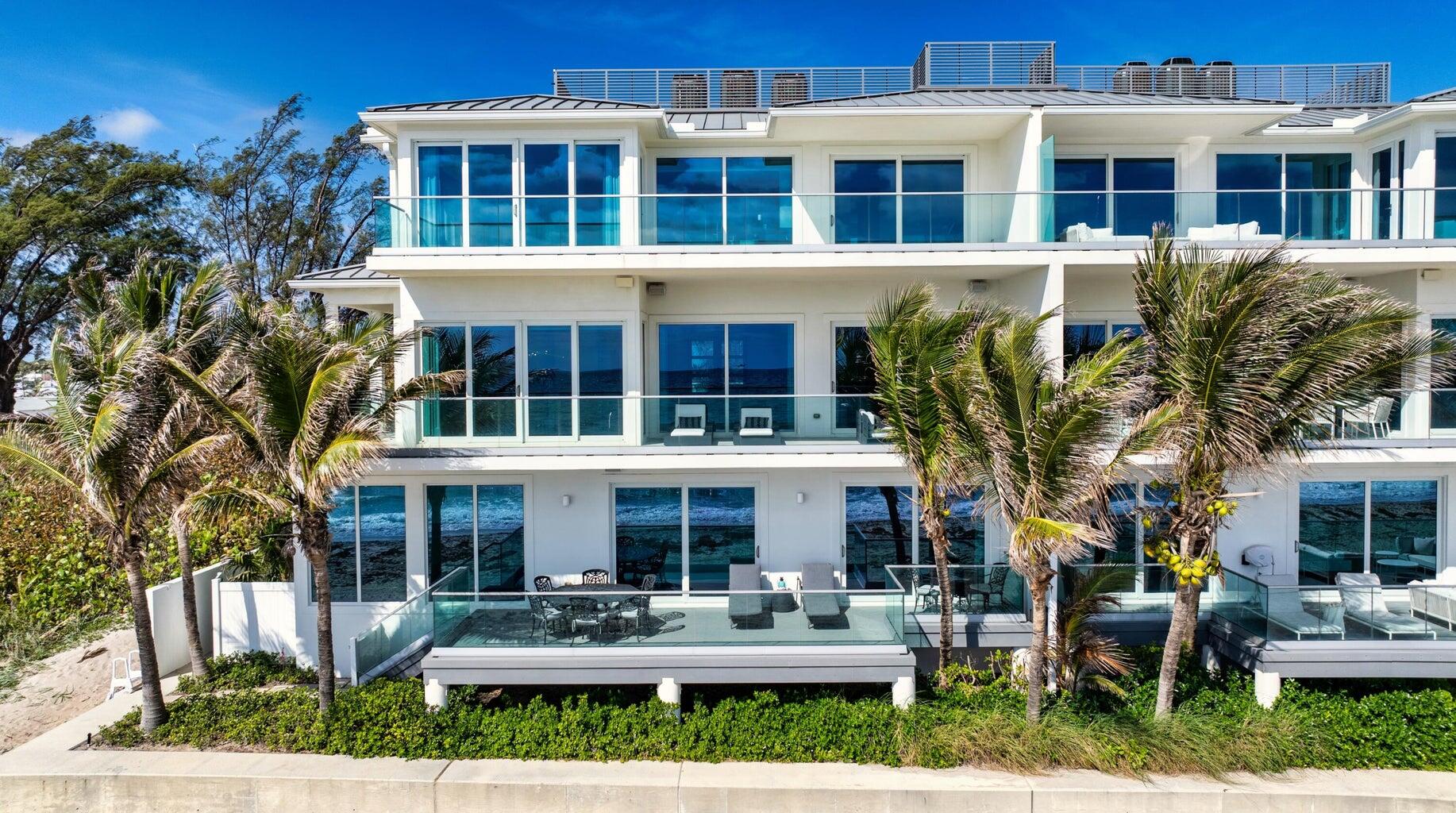 5001 Old Ocean Boulevard Ocean Ridge, FL 33435 - Photo 65 of 66 a front view of residential building with outdoor seating and covered trees