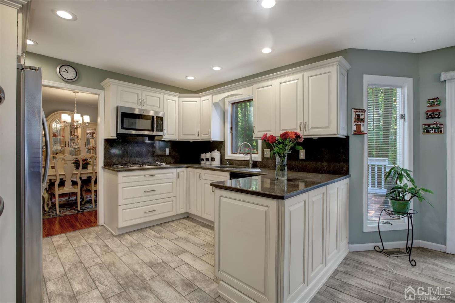 11 Walnut Court Old Bridge, NJ 07747 - Photo 11 of 32 a kitchen with stainless steel appliances kitchen island granite countertop a refrigerator and microwave