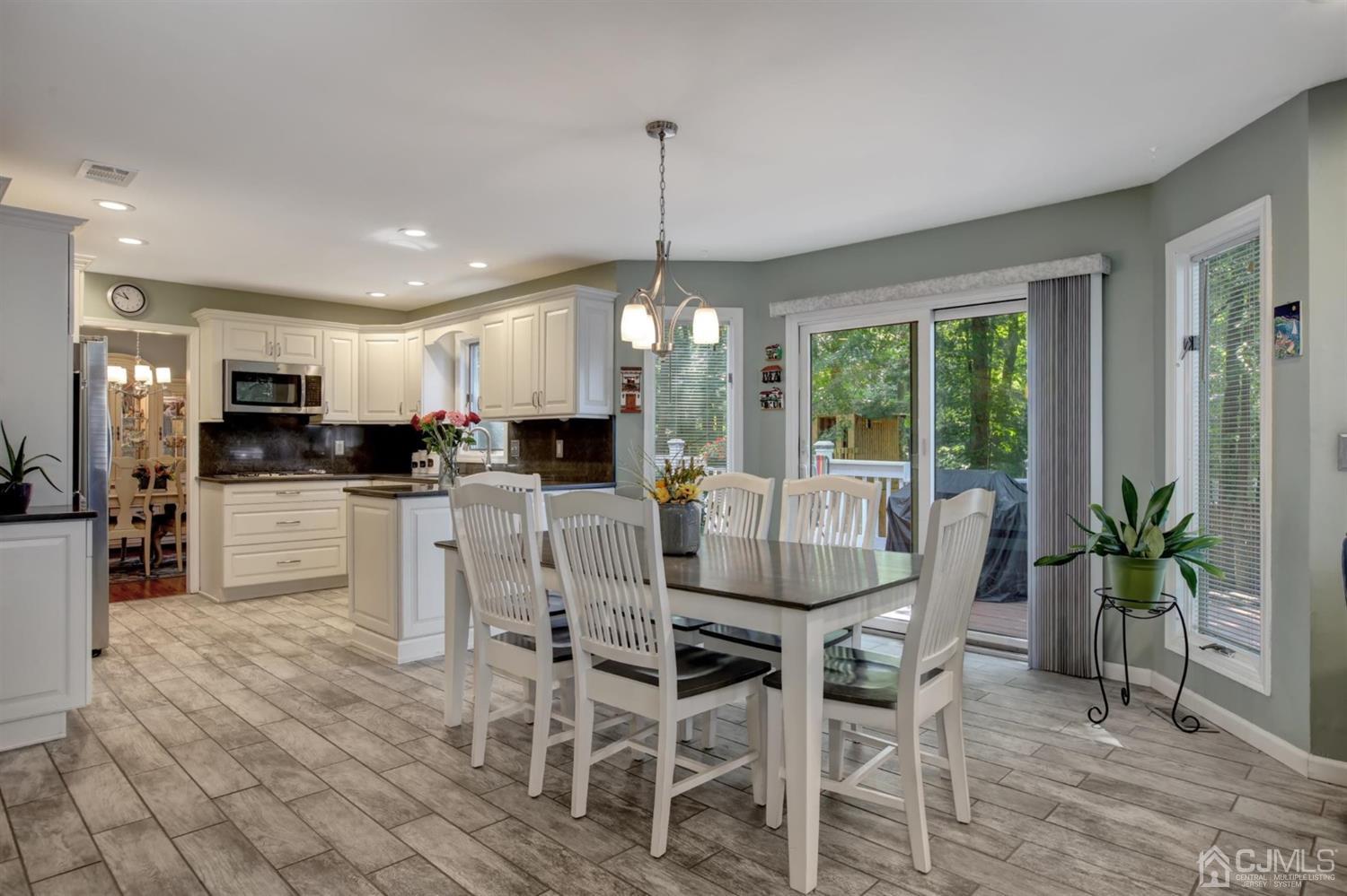 11 Walnut Court Old Bridge, NJ 07747 - Photo 13 of 32 a kitchen with microwave a refrigerator and chairs