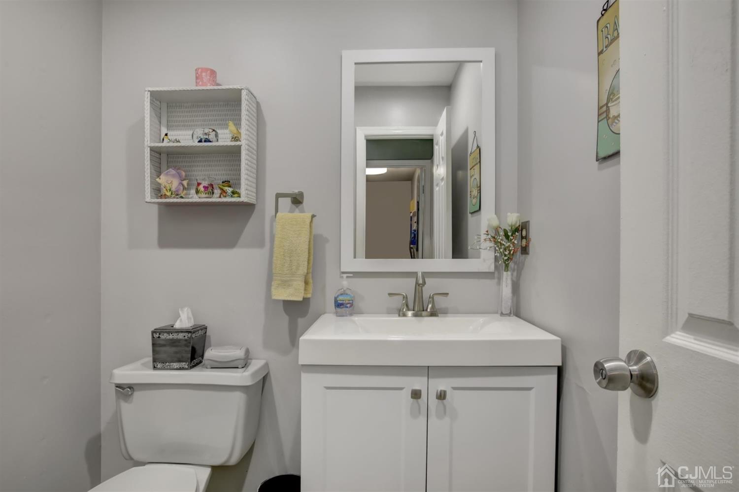 11 Walnut Court Old Bridge, NJ 07747 - Photo 16 of 32 a bathroom with a toilet sink and mirror