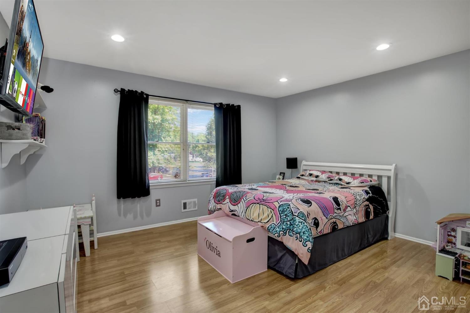 11 Walnut Court Old Bridge, NJ 07747 - Photo 22 of 32 a bedroom with a bed and a flat screen tv