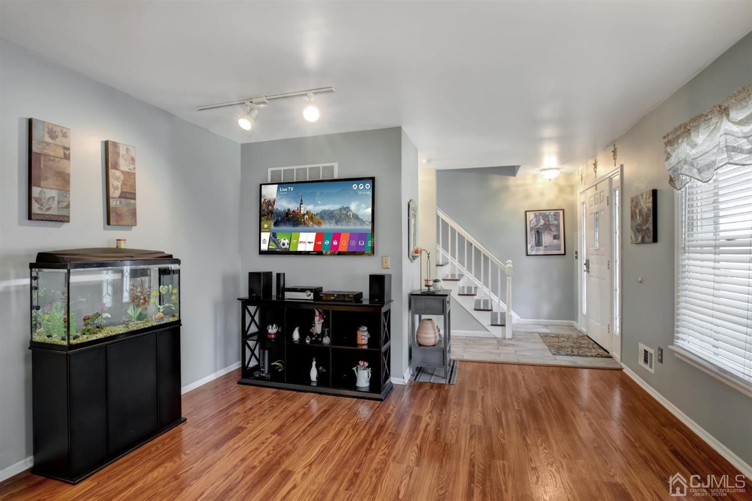 11 Walnut Court Old Bridge, NJ 07747 - Photo 6 of 32 a view of game room with wooden floor and windows