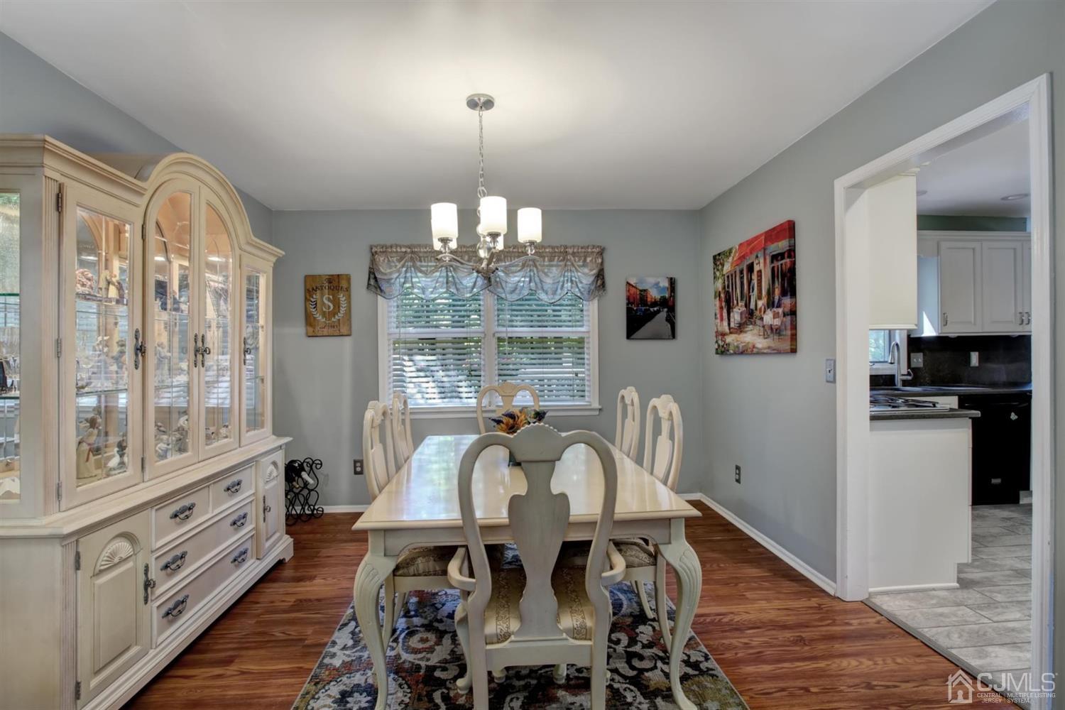 11 Walnut Court Old Bridge, NJ 07747 - Photo 9 of 32 a view of a dining room with furniture a chandelier and wooden floor