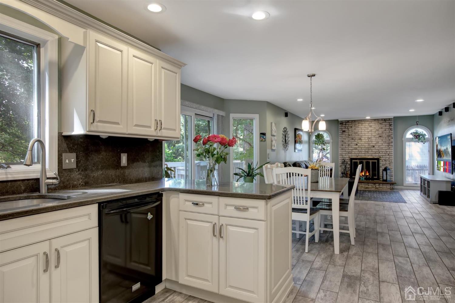 11 Walnut Court Old Bridge, NJ 07747 - Photo 10 of 32 a kitchen with stainless steel appliances kitchen island granite countertop a table chairs sink and cabinets