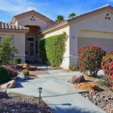 front view of a house with a bench