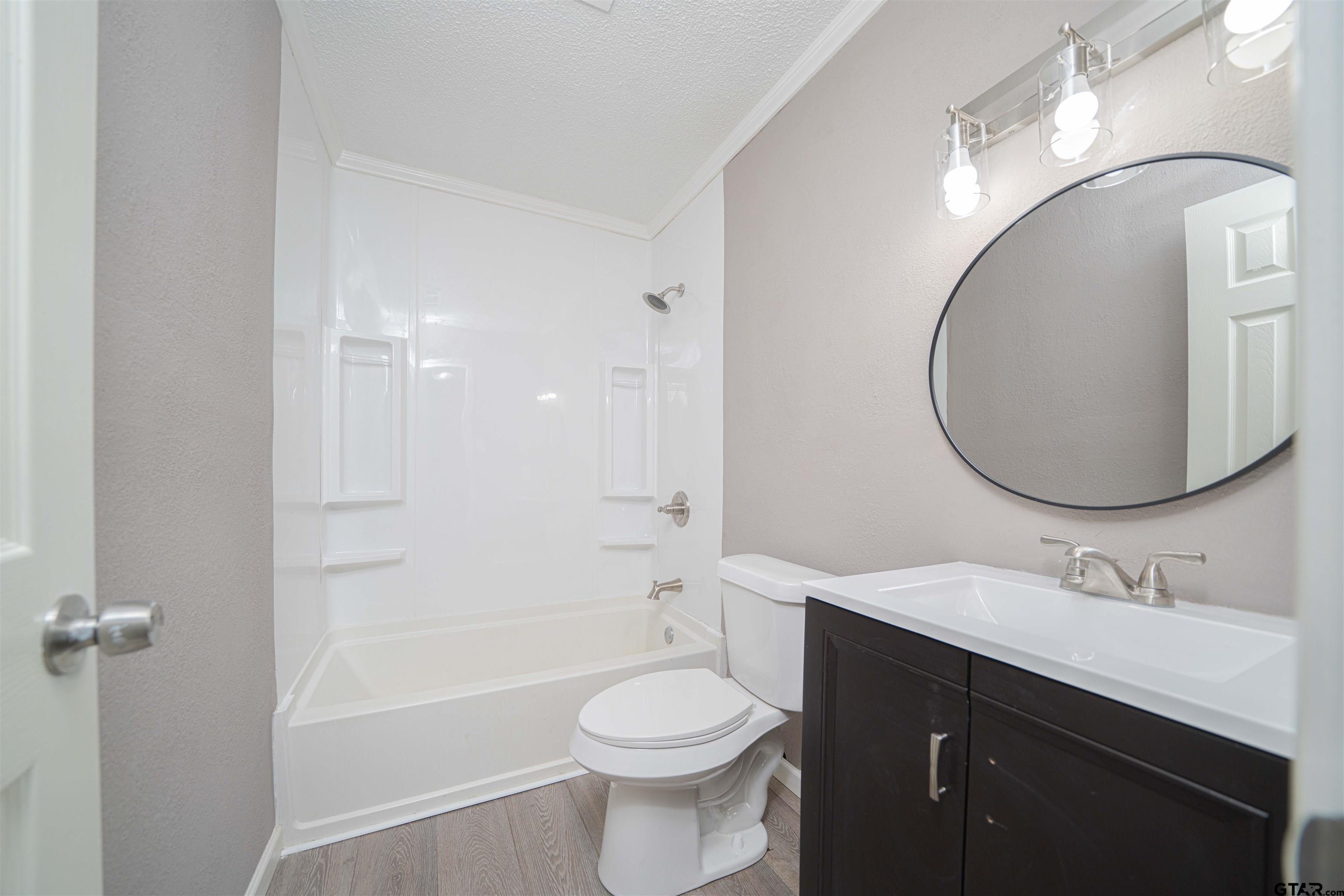 2802 Granite Drive Longview, TX 75604 - Photo 10 of 19 a bathroom with a sink toilet and shower