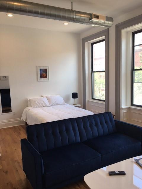 4407 Butler Street Pittsburgh, PA 15201 - Photo 12 of 29 a living room with a couch and a table