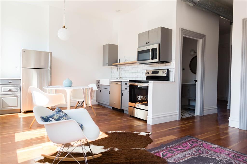 4407 Butler Street Pittsburgh, PA 15201 - Photo 21 of 29 a living room with stainless steel appliances furniture and a wooden floor