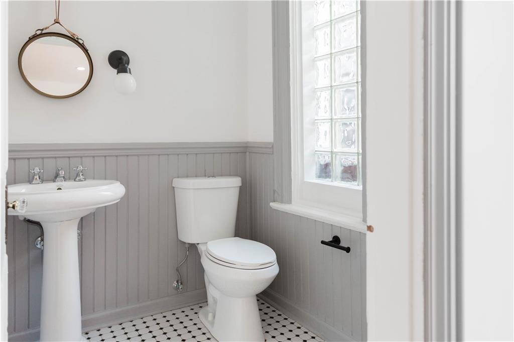 4407 Butler Street Pittsburgh, PA 15201 - Photo 22 of 29 a bathroom with a toilet sink and mirror