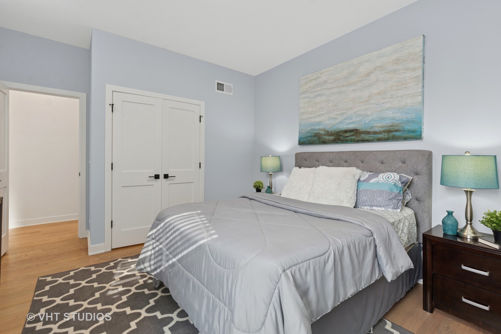 847 West Ainslie Street, Unit 3E Chicago, IL 60640 - Photo 13 of 19 a bedroom with a bed and wooden floor