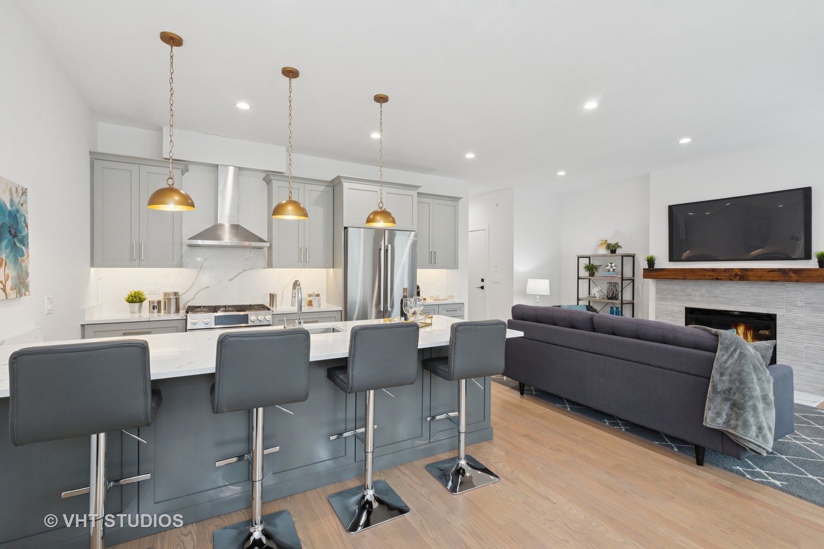 847 West Ainslie Street, Unit 3E Chicago, IL 60640 - Photo 7 of 19 a living room with furniture a fireplace and a flat screen tv