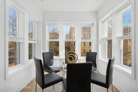 a view of a dining room with furniture and windows