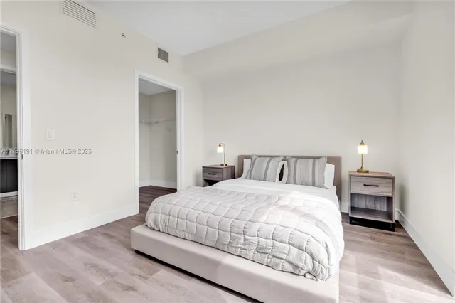 a bedroom with a bed and a night stand