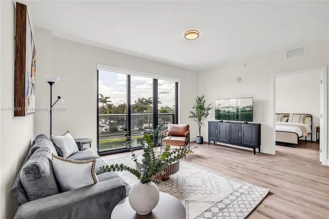 a living room with furniture and a large window