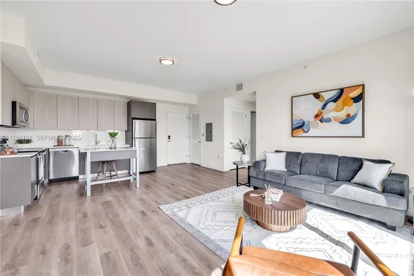 a living room with furniture and a wooden floor