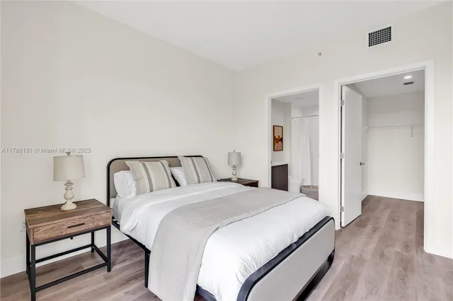 a bedroom with a bed and a lamp on table