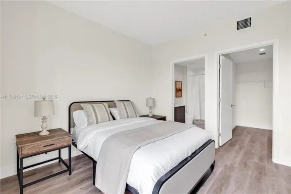 a bedroom with a bed and a lamp on table