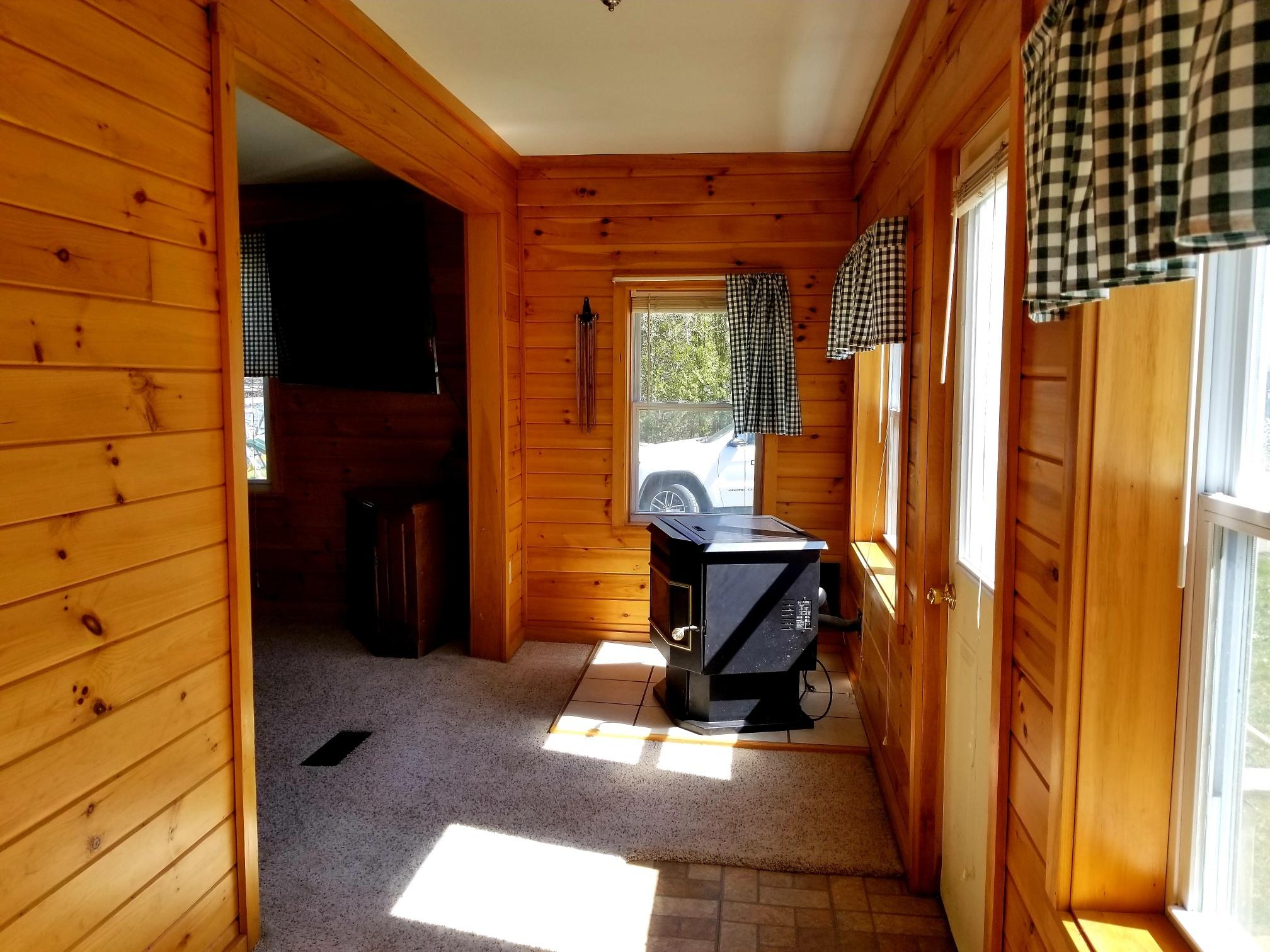 15 Crummett Street Waterville, ME 04901 - Photo 16 of 35 Sun Room with Pellet Stove