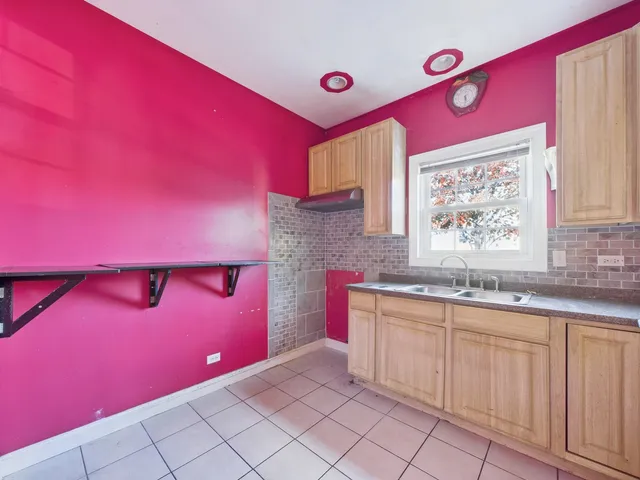 a kitchen with white cabinets and a sink