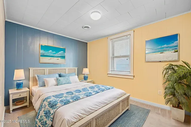 a bedroom with a bed and a potted plant