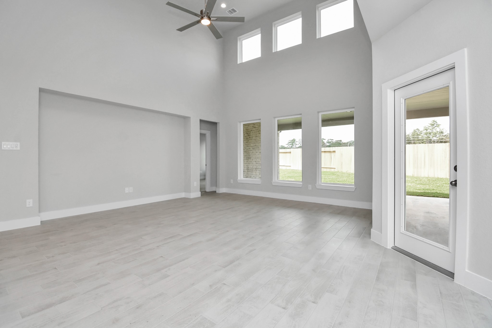 3043 Native Spg Drive Spring, TX 77373 - Photo 19 of 39 Welcome family and guests to your charming living room! With its high ceilings, recessed lighting, ceiling fan, custom paint, beautiful flooring, and large windows that let in abundant natural light, this room is perfect for gatherings. Sample photo of completed home with similar floor plan. Actual colors and selections may vary.