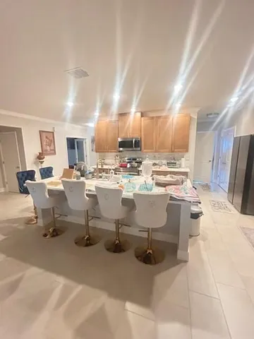 a living room with lots of furniture and kitchen view