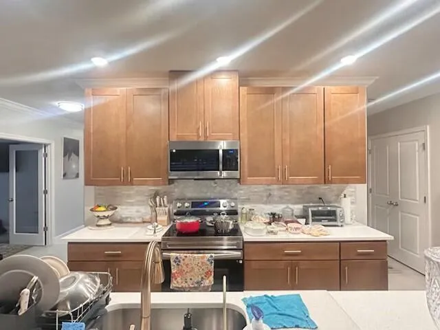 a kitchen with a sink cabinets and window