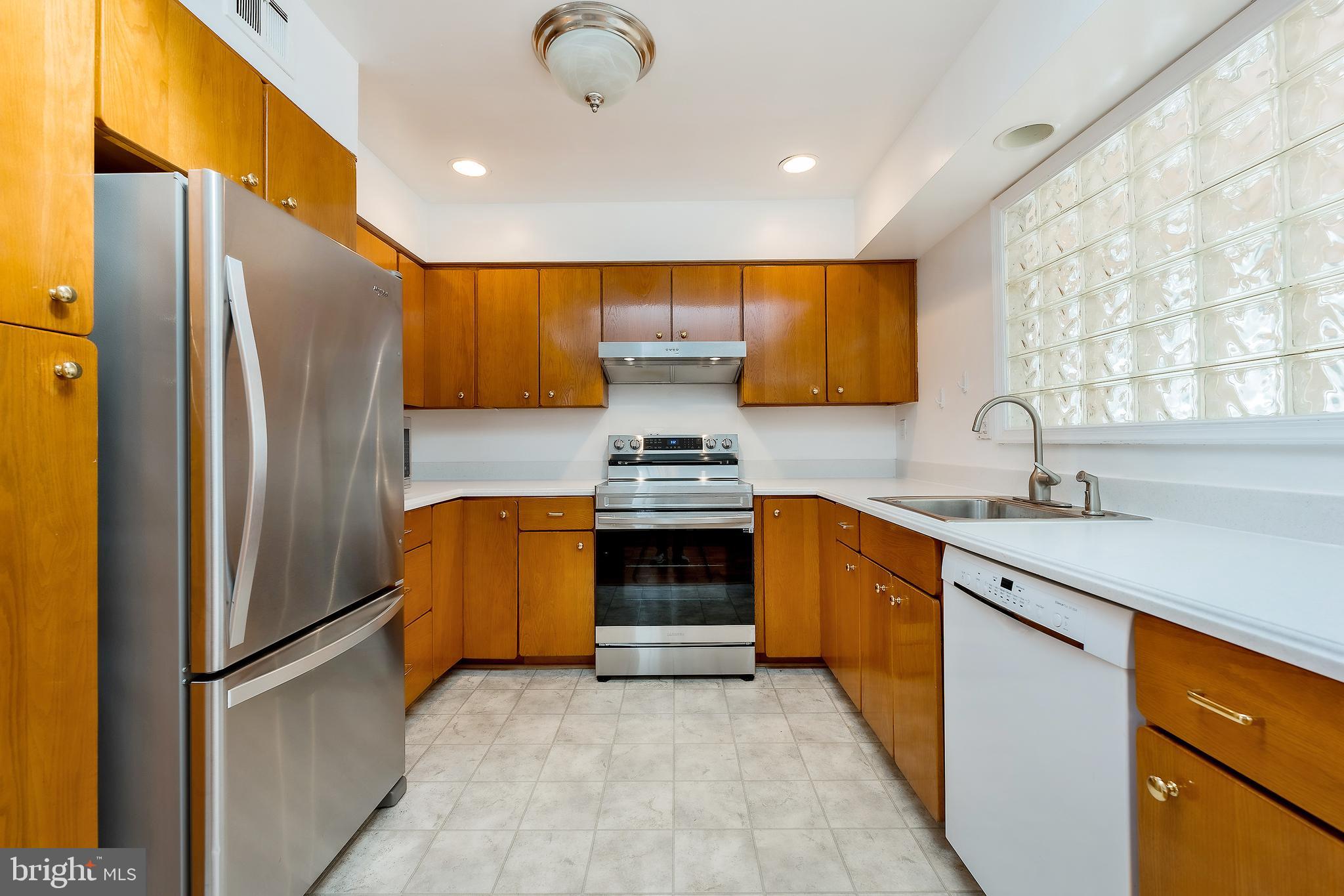 6504 Stratford Road Chevy Chase, MD 20815 - Photo 13 of 54 a kitchen with granite countertop a refrigerator and a sink
