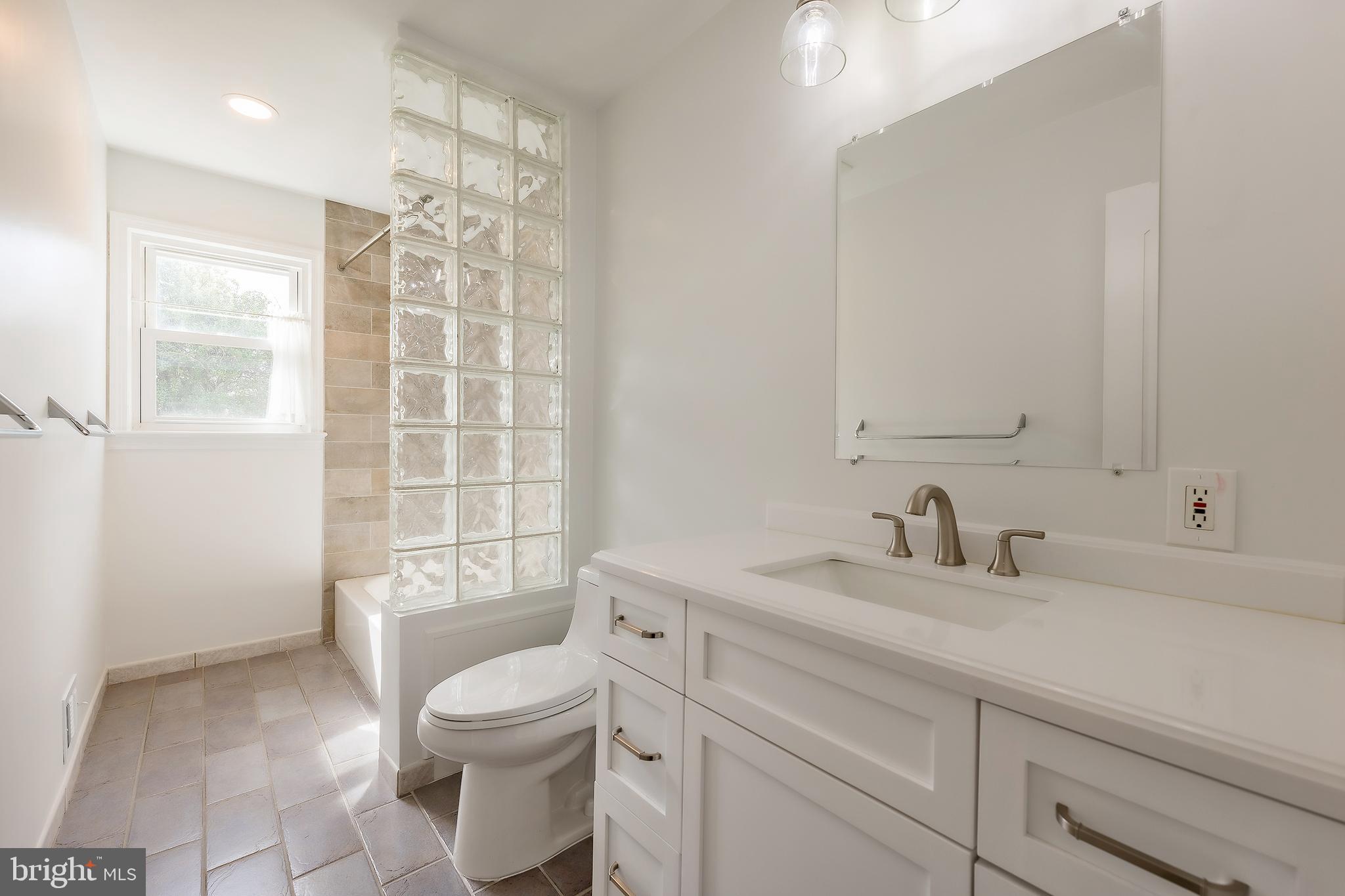 6504 Stratford Road Chevy Chase, MD 20815 - Photo 23 of 54 a bathroom with a sink toilet vanity and tub
