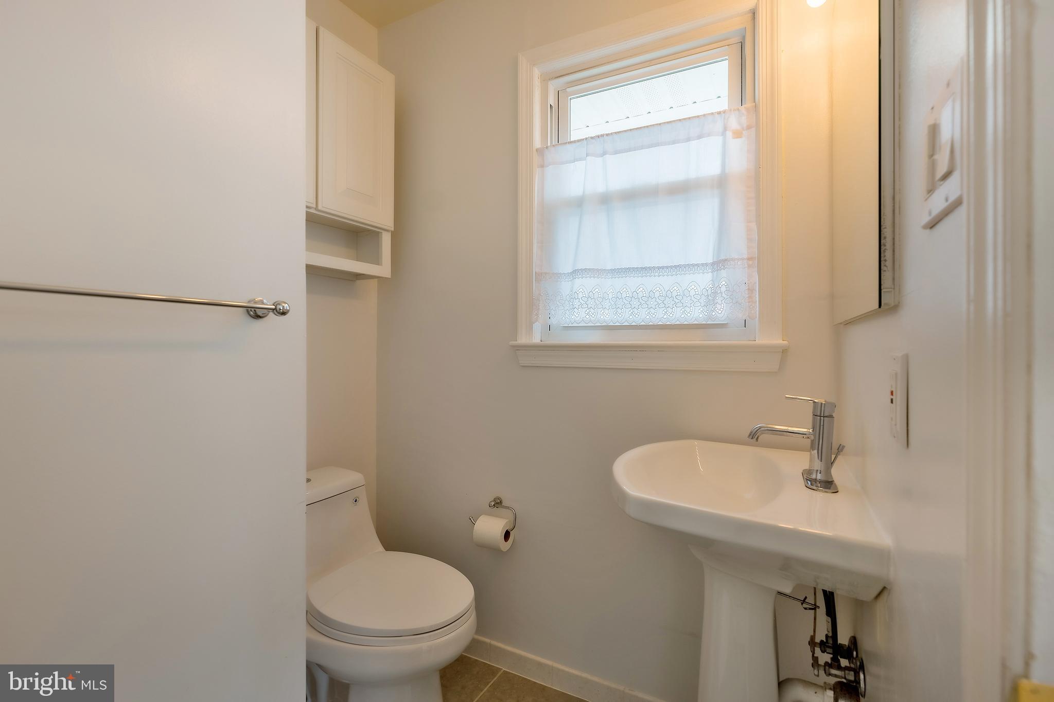 6504 Stratford Road Chevy Chase, MD 20815 - Photo 27 of 54 a bathroom with a sink toilet and a mirror