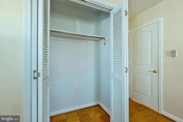 a view of an empty room with a chandelier fan
