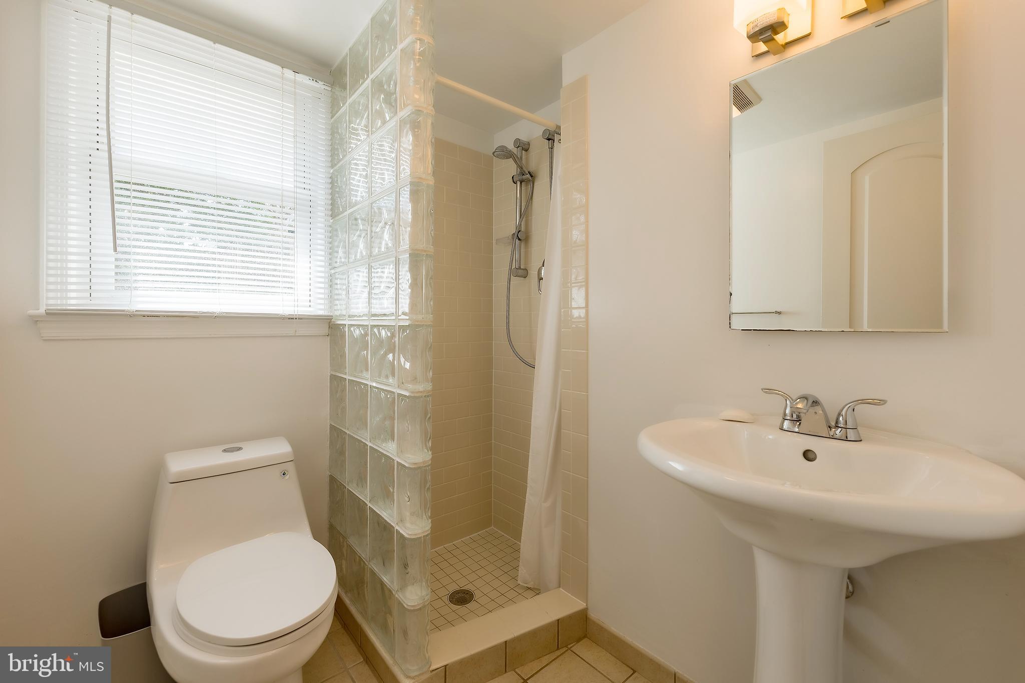 6504 Stratford Road Chevy Chase, MD 20815 - Photo 41 of 54 a bathroom with a sink a toilet and shower