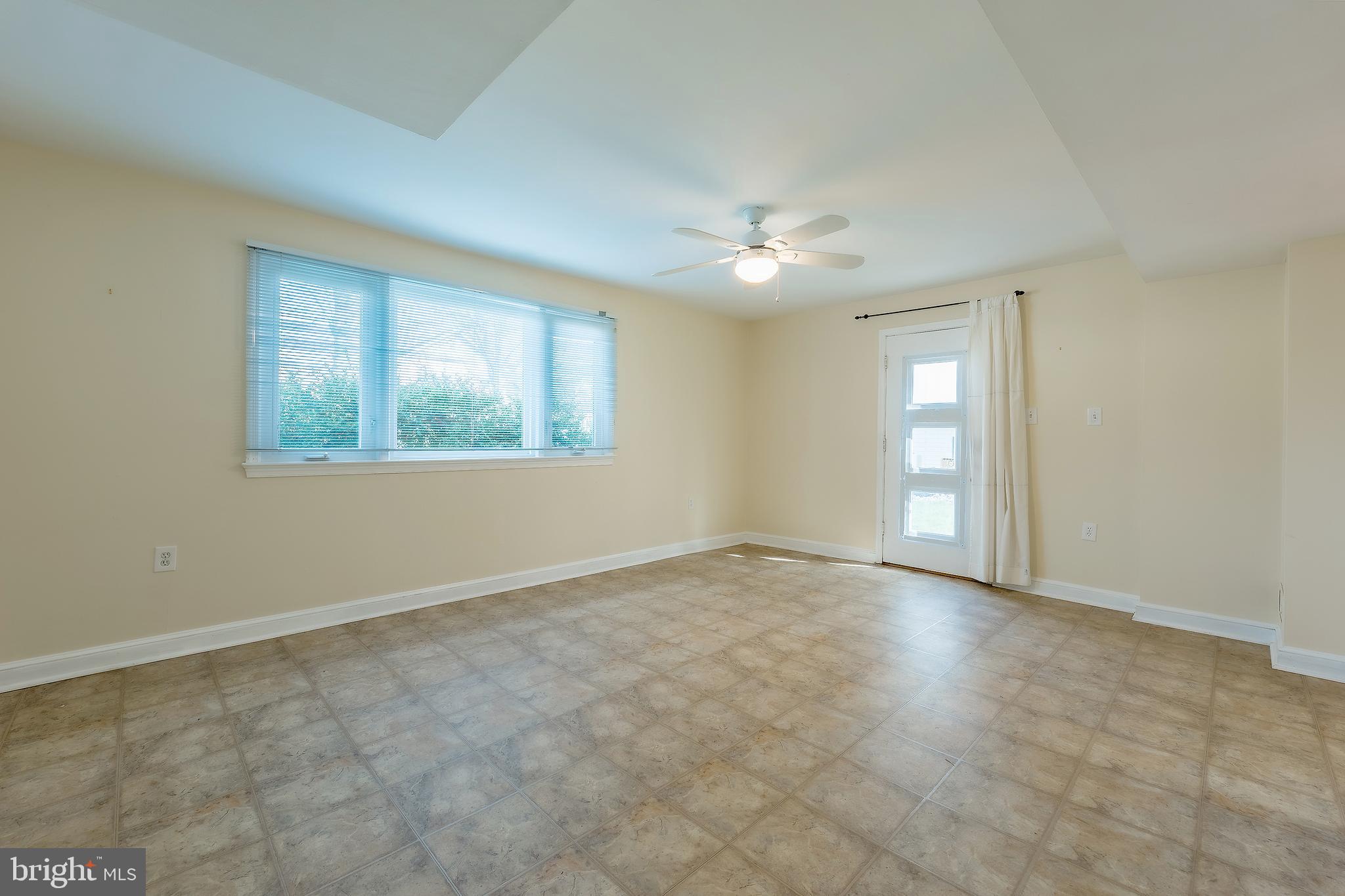 6504 Stratford Road Chevy Chase, MD 20815 - Photo 45 of 54 an empty room with windows and fan