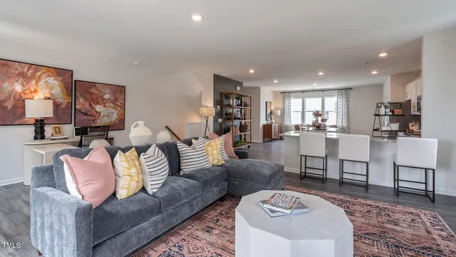 a kitchen with stainless steel appliances kitchen island granite countertop a table chairs and a refrigerator