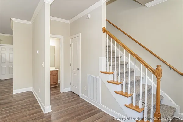 a view of an entryway with wooden floor and stairs