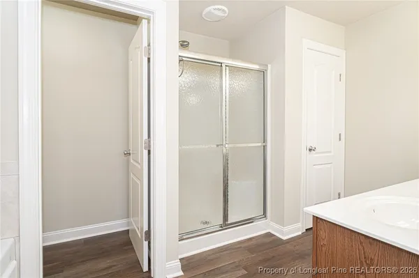 a view of a room with wooden floor