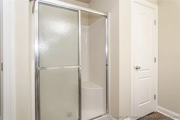 a bathroom with a glass shower door
