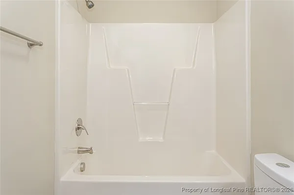 a bathroom with a bathtub and a toilet