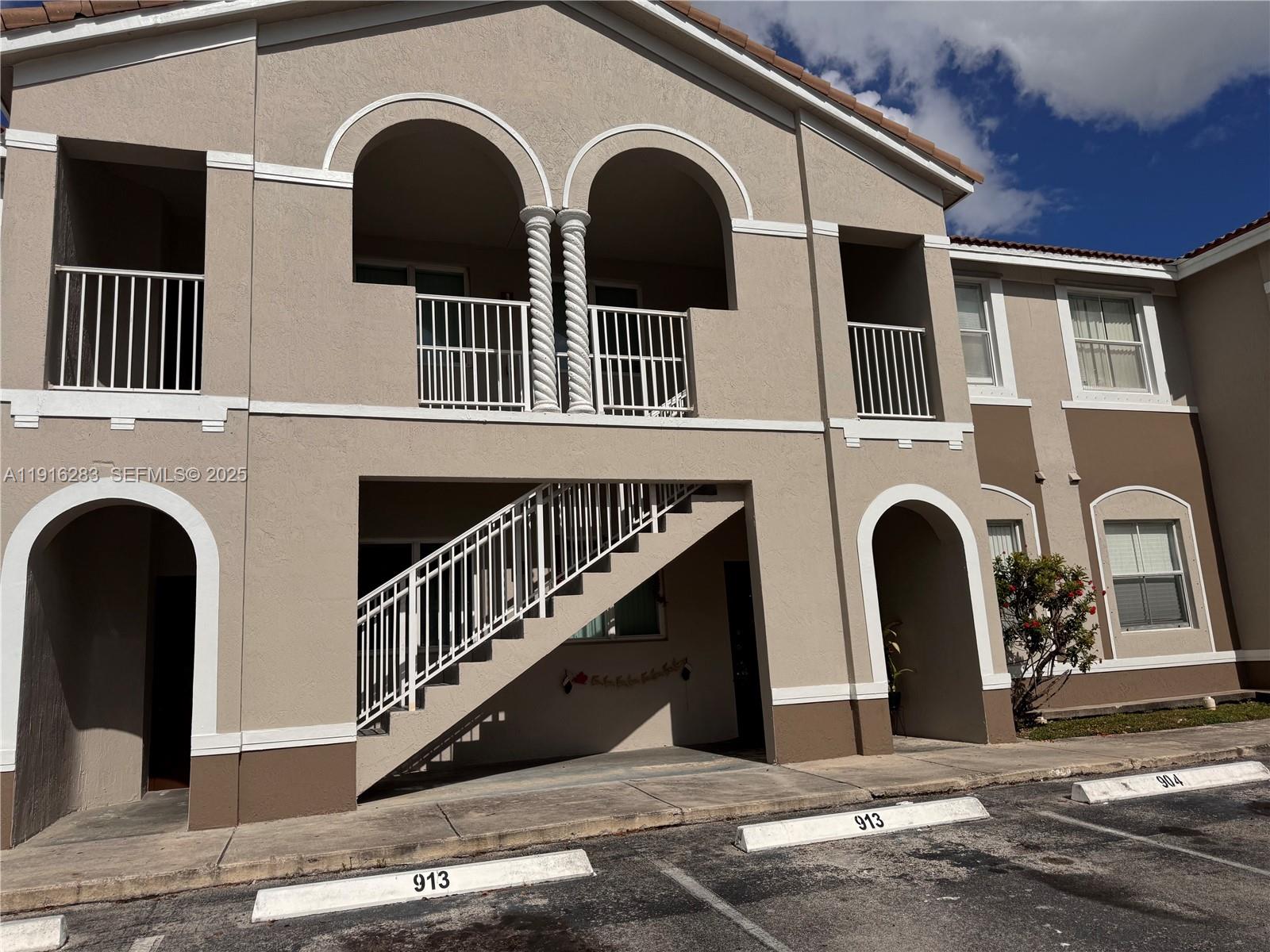 1663 Southeast 29th Street, Unit 202 Homestead, FL 33035 - Photo 2 of 9 a front view of a house with windows