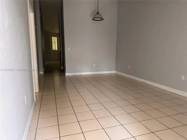 a view of an empty room and wooden door