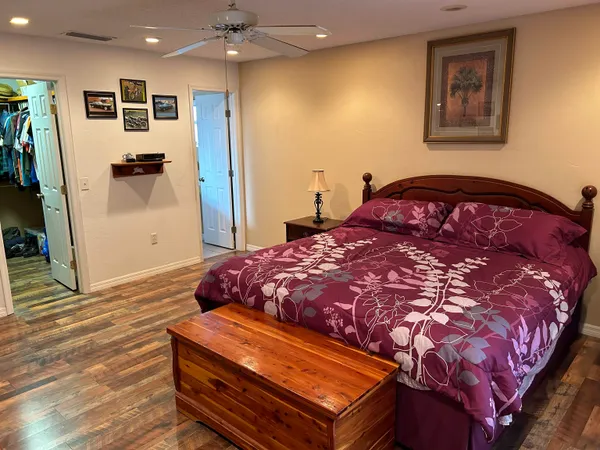 a bedroom with a bed and a mirror